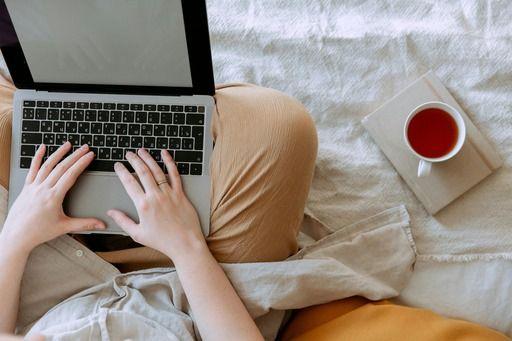 person working on a laptop next to coffee